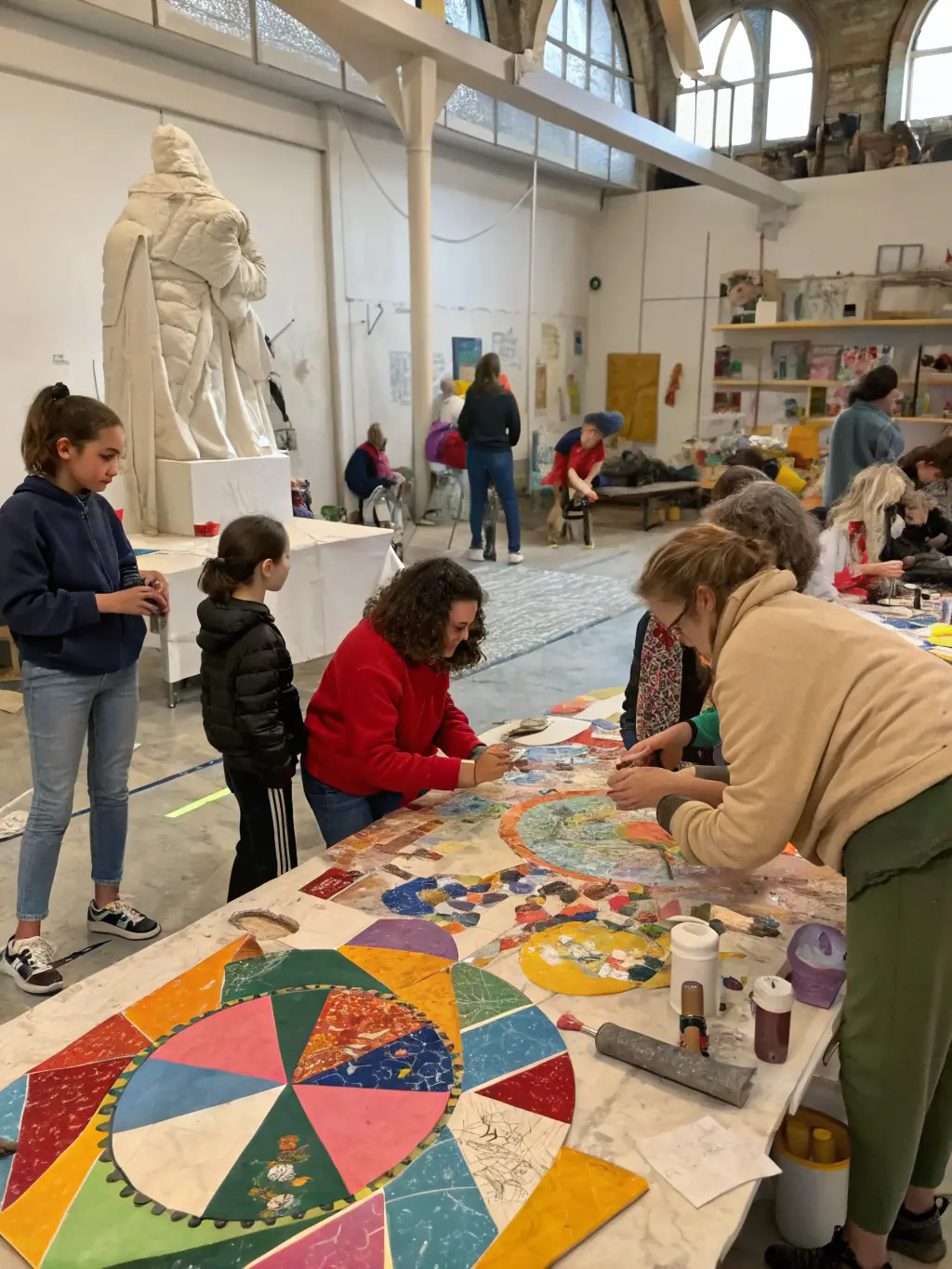A photograph of a community workshop hosted by CIE Richard Martin, showing participants actively engaged in a creative activity, such as painting or sculpting.